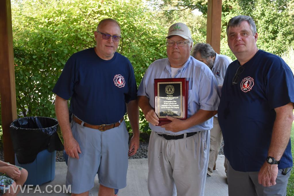 Wiccopee President Tom Hussing & Assistant Chief John Ryan presenting a certificate to William McClellan for 50 years